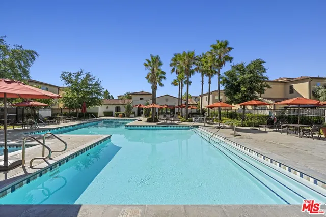 a view of a swimming pool with lounge chair