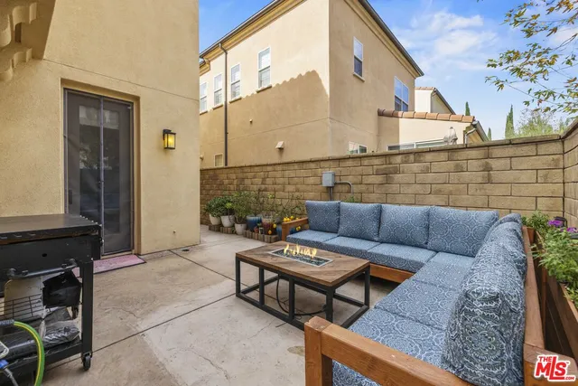 a view of a patio with couches and potted plants