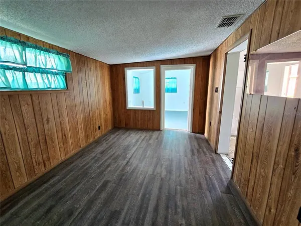 a view of a room with wooden floor and natural light