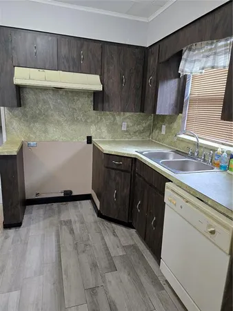 a kitchen with a sink a stove and cabinets