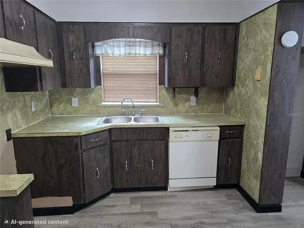 a kitchen with a sink cabinets and wooden floor