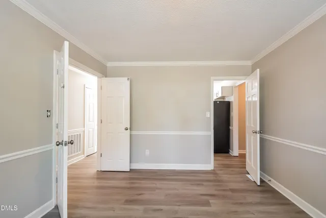 a view of an empty room with wooden floor