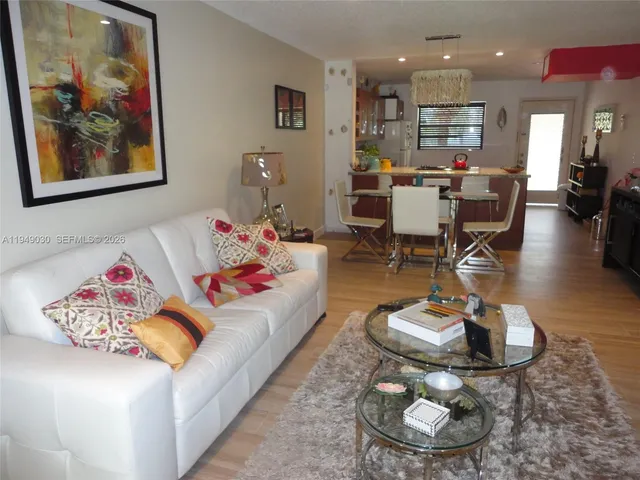 a living room with furniture and kitchen view