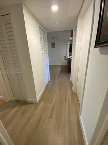 a view of a hallway and wooden floor