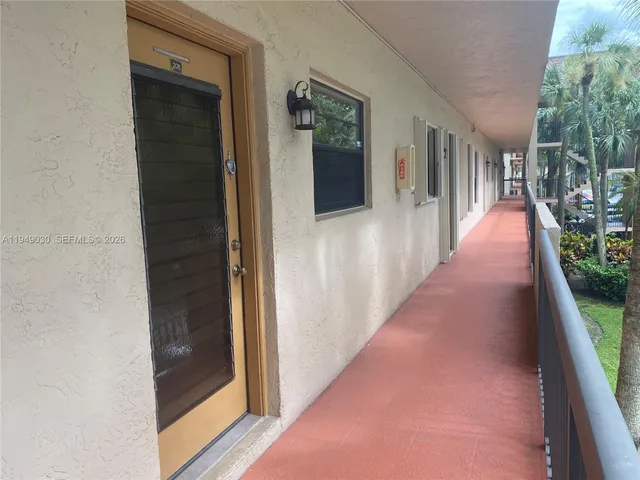a car parked in front of a white house