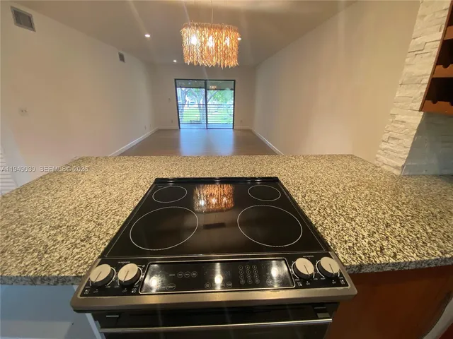 a stove top oven sitting inside of a kitchen