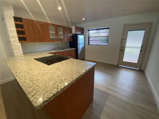 a kitchen with granite countertop sink and cabinets