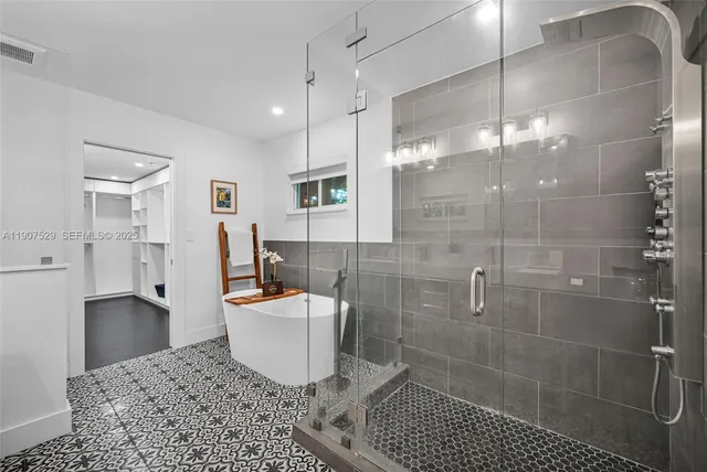 a bedroom with a bed and a wooden floor