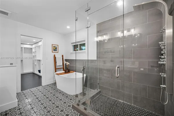 a bedroom with a bed window and a mirror