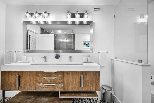 a bedroom with a bed and large windows