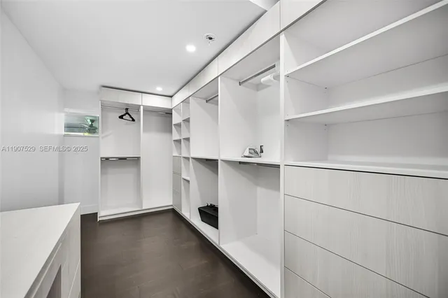 a bedroom with a bed and a ceiling fan