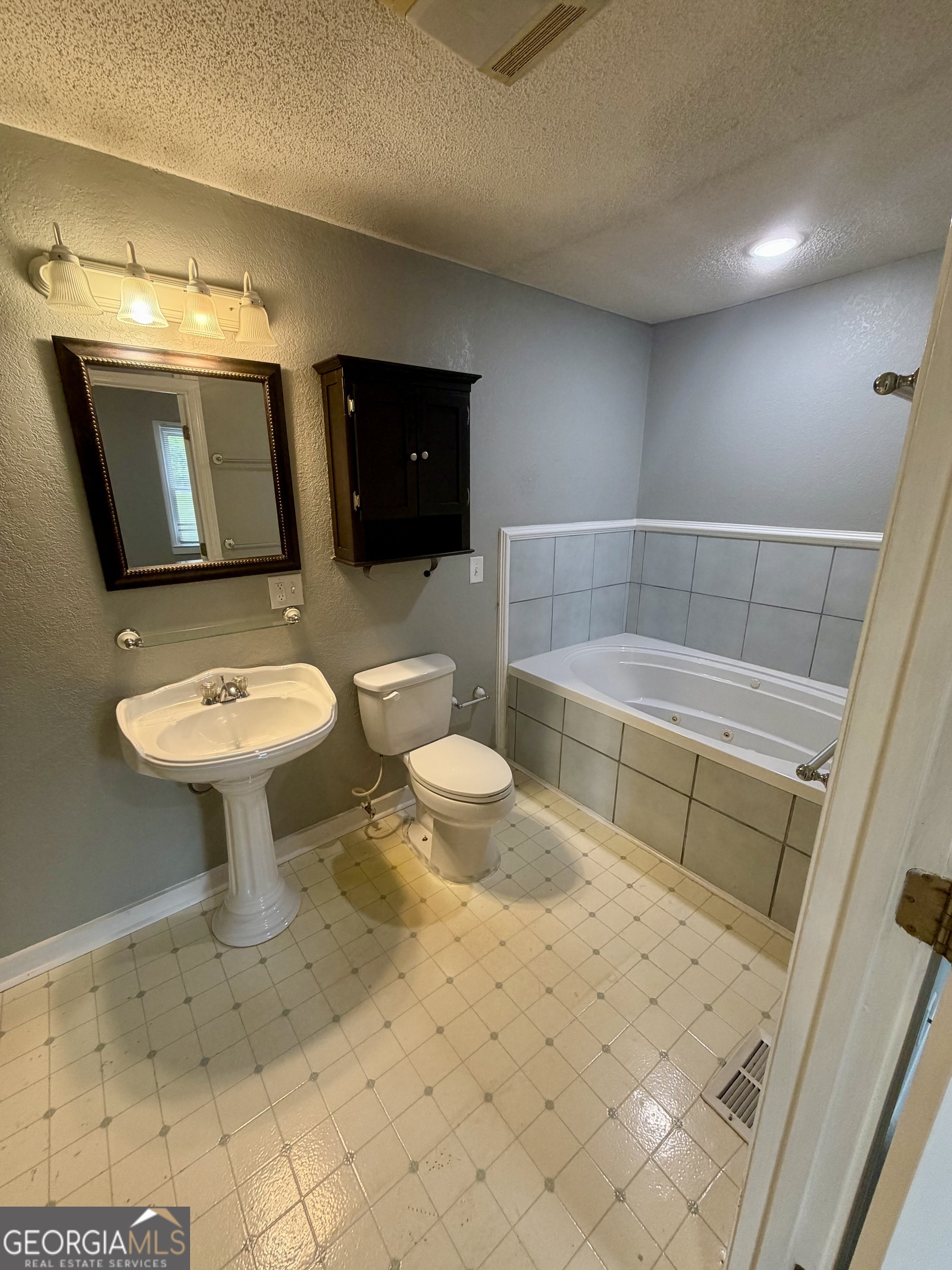666 Woolfolk Street Macon, GA 31217 - Photo 42 of 60 a bathroom with a sink toilet and shower