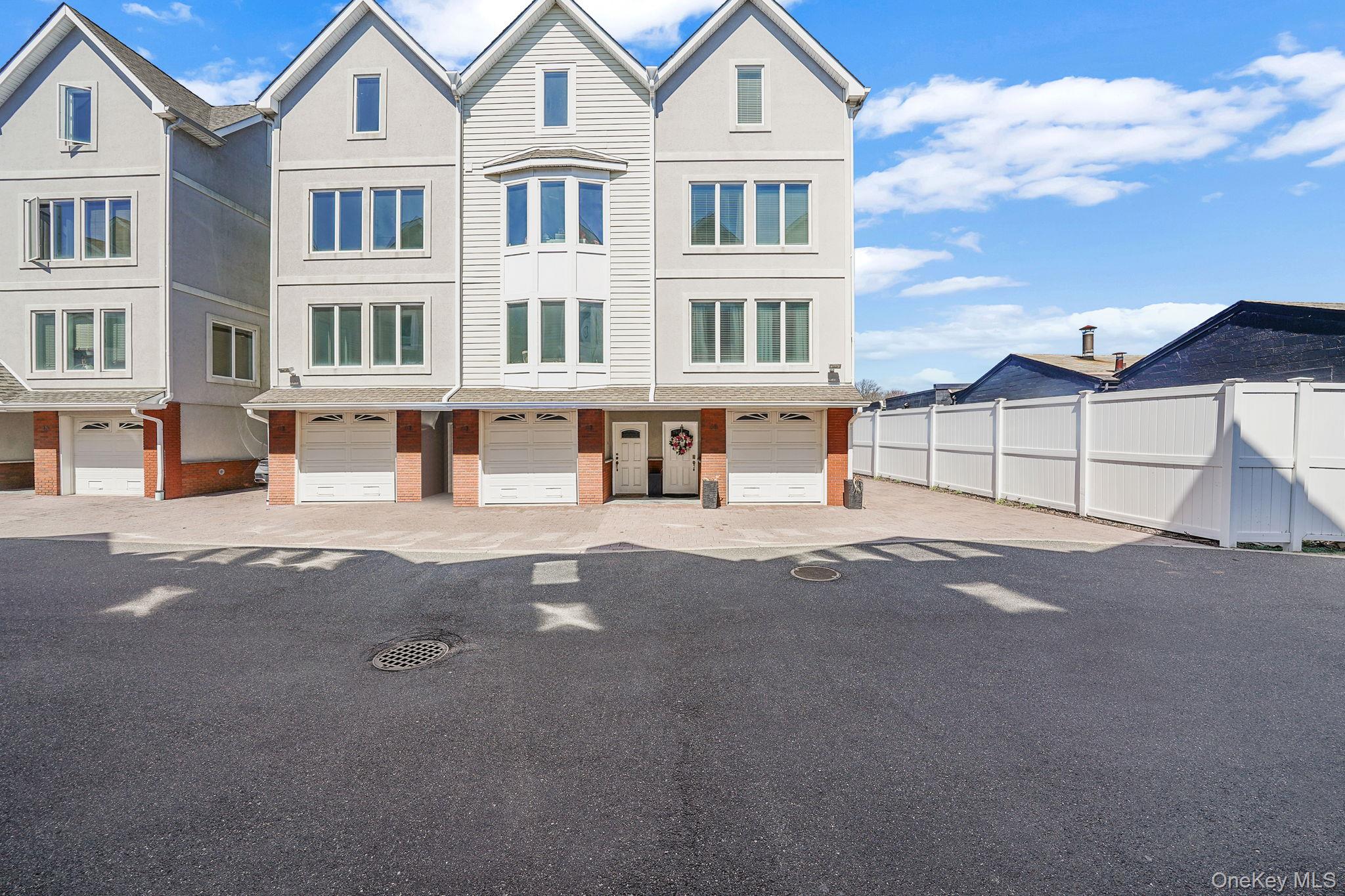 531 Ray Street, Unit 10 Freeport, NY 11520 - Photo 1 of 32 a view of multiple houses with a street