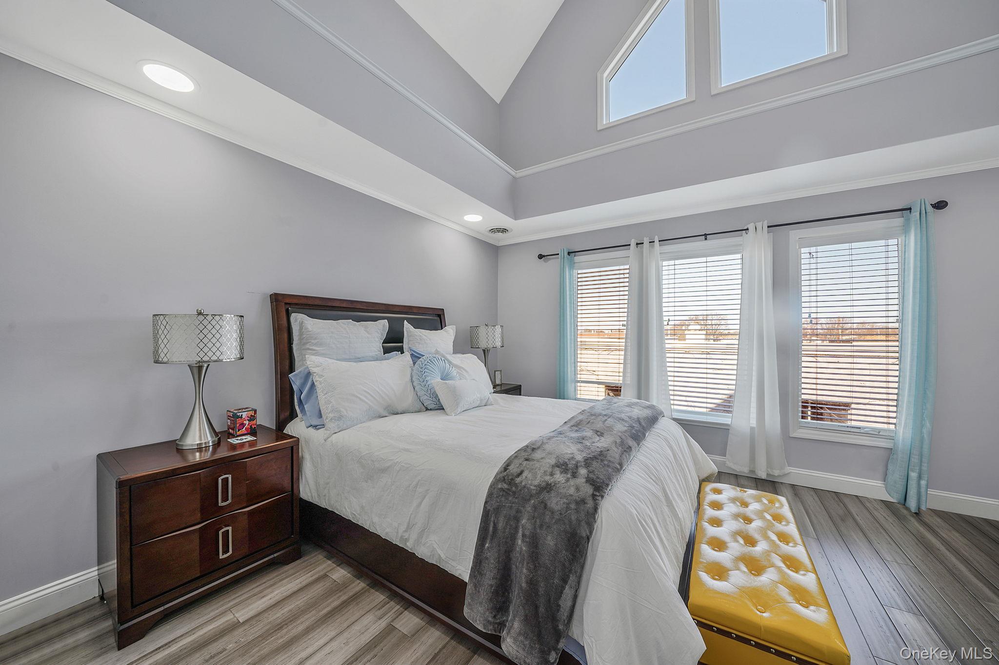 531 Ray Street, Unit 10 Freeport, NY 11520 - Photo 12 of 32 a bedroom with a bed and wooden floor