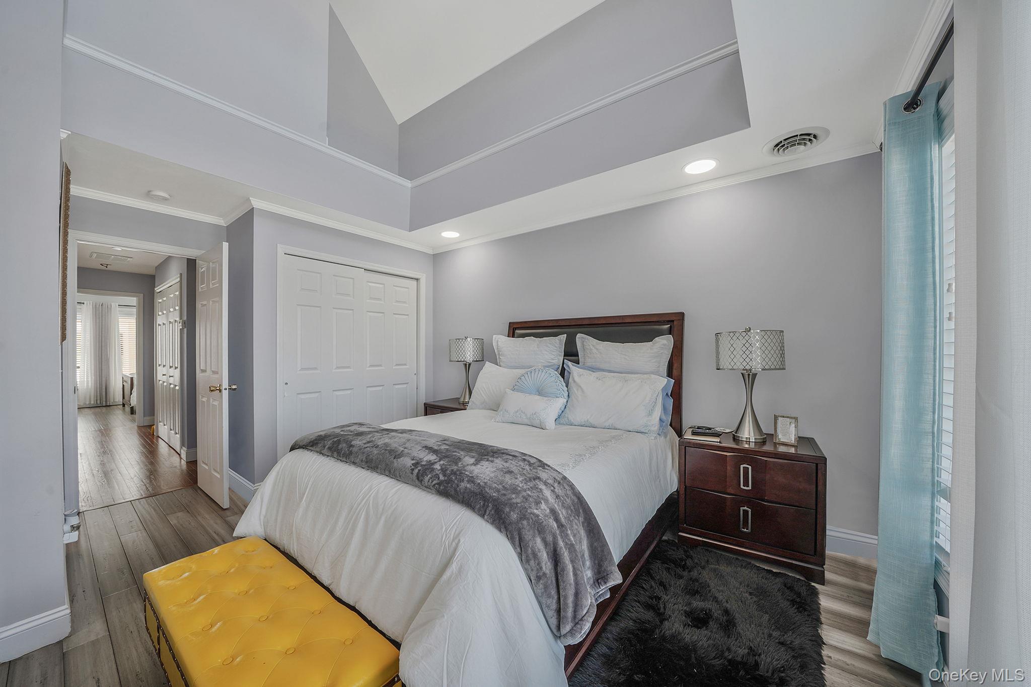 531 Ray Street, Unit 10 Freeport, NY 11520 - Photo 13 of 32 a bedroom with a bed and wooden floor