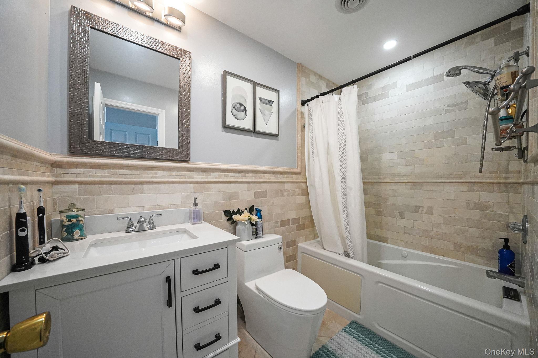 531 Ray Street, Unit 10 Freeport, NY 11520 - Photo 15 of 32 a bathroom with a sink toilet tub and shower