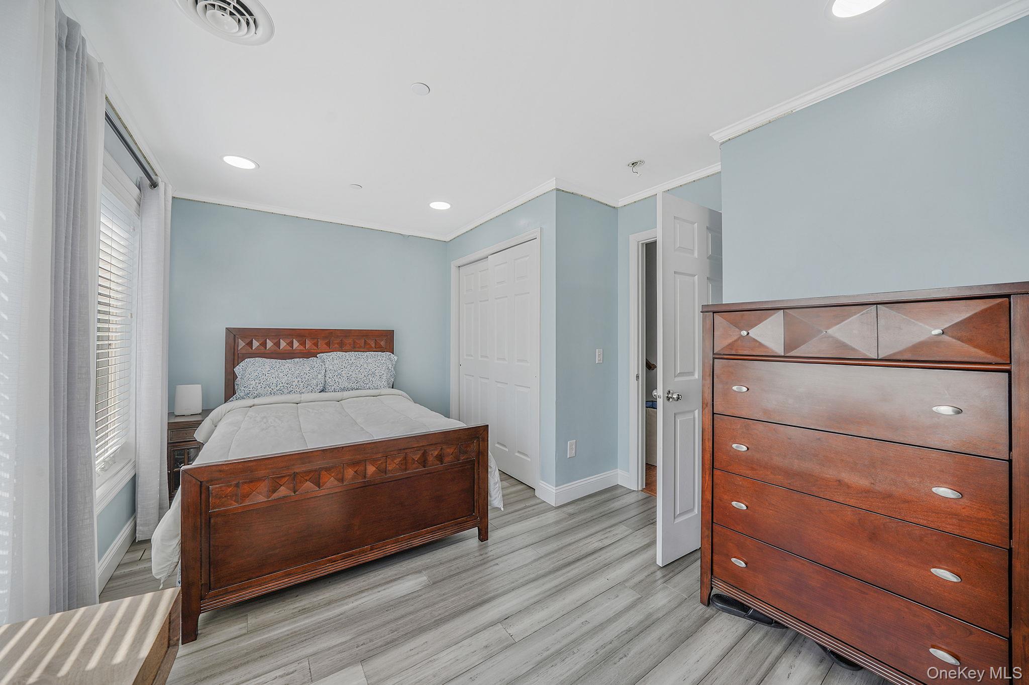 531 Ray Street, Unit 10 Freeport, NY 11520 - Photo 17 of 32 a bedroom with a bed and a dresser