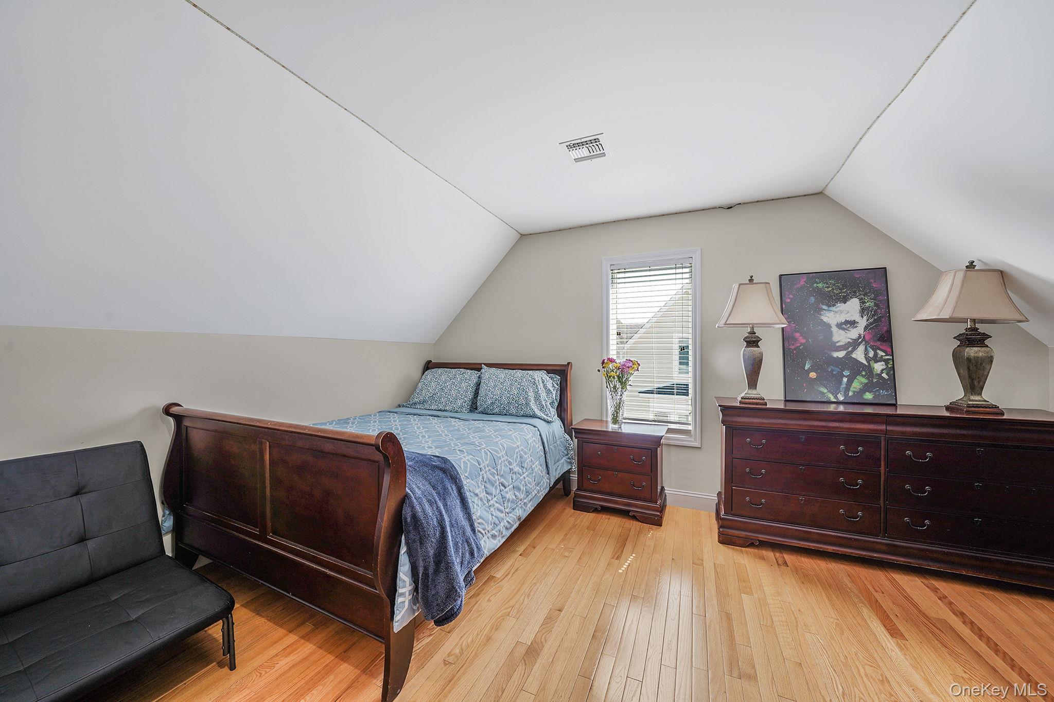 531 Ray Street, Unit 10 Freeport, NY 11520 - Photo 21 of 32 a bedroom with a bed and window