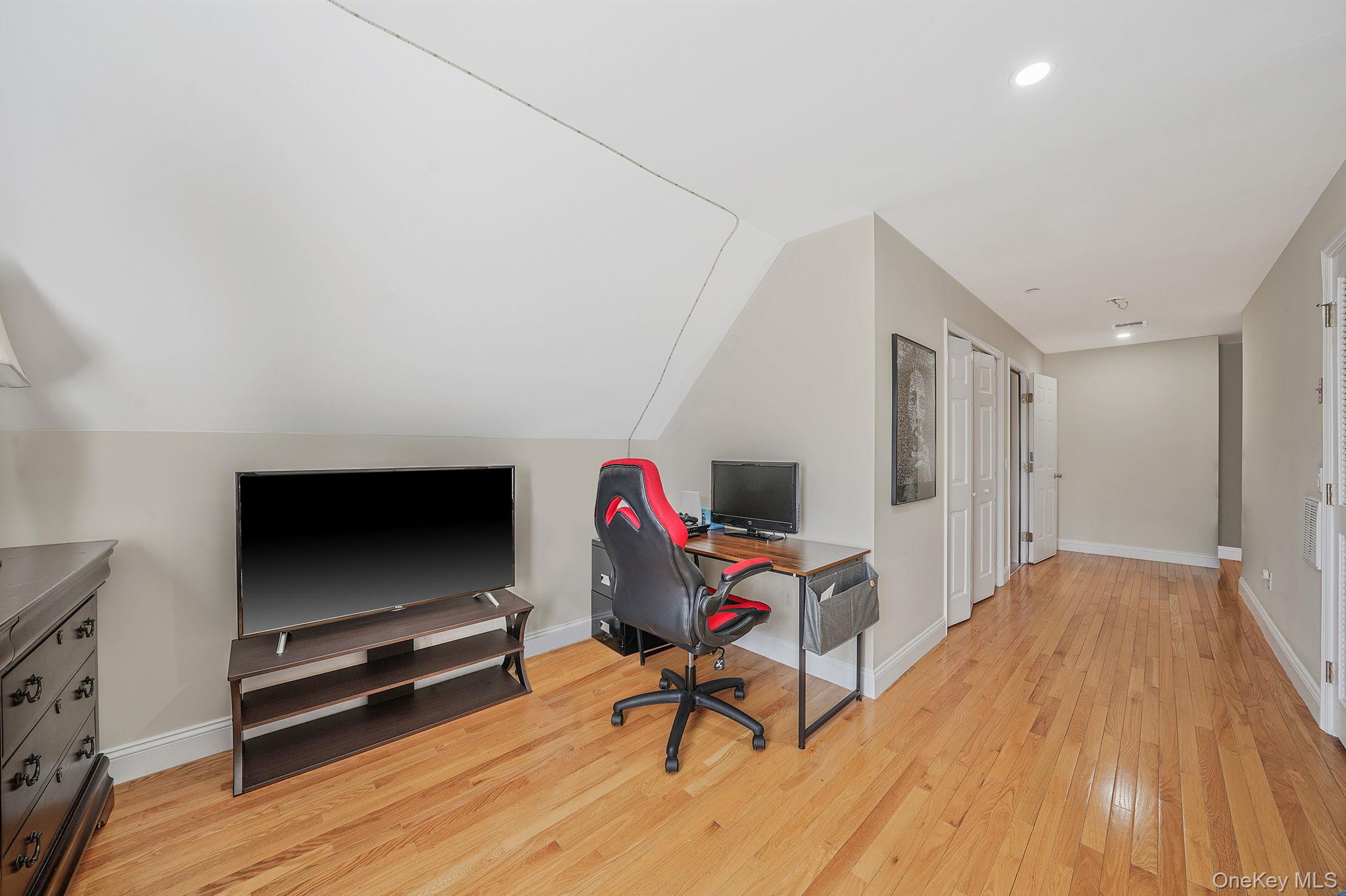 531 Ray Street, Unit 10 Freeport, NY 11520 - Photo 22 of 32 a living room with furniture and a flat screen tv