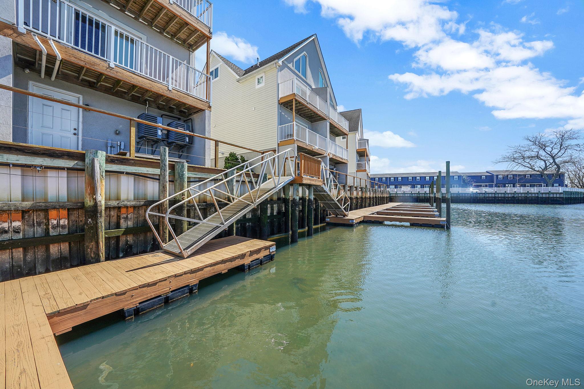 531 Ray Street, Unit 10 Freeport, NY 11520 - Photo 25 of 32 a view of a lake with boats and a small yard