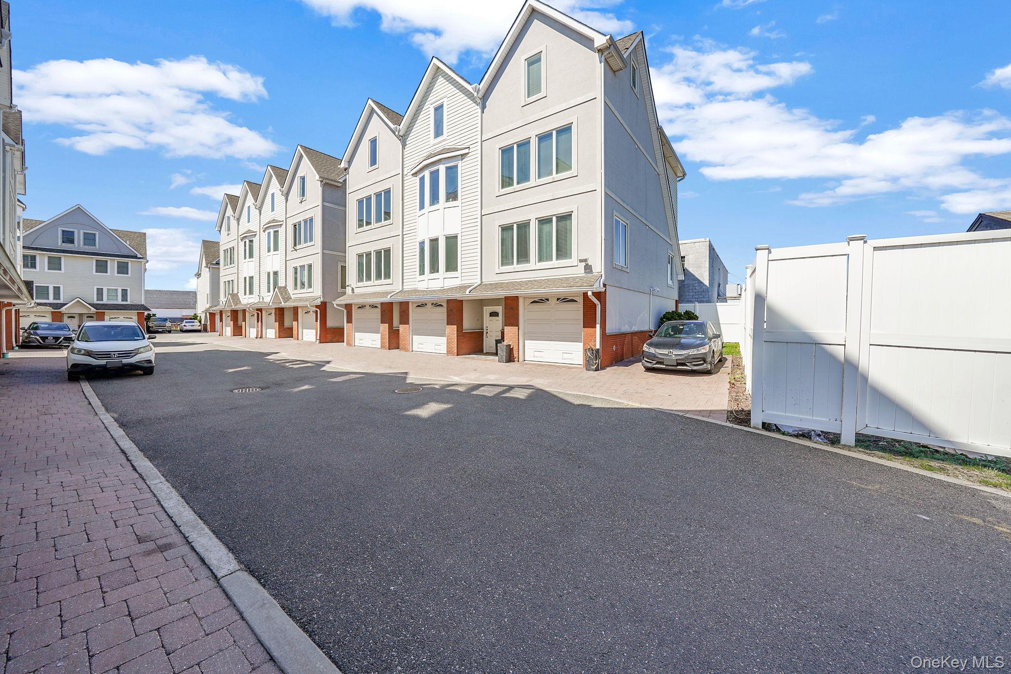 531 Ray Street, Unit 10 Freeport, NY 11520 - Photo 32 of 32 a city street lined with buildings and cars