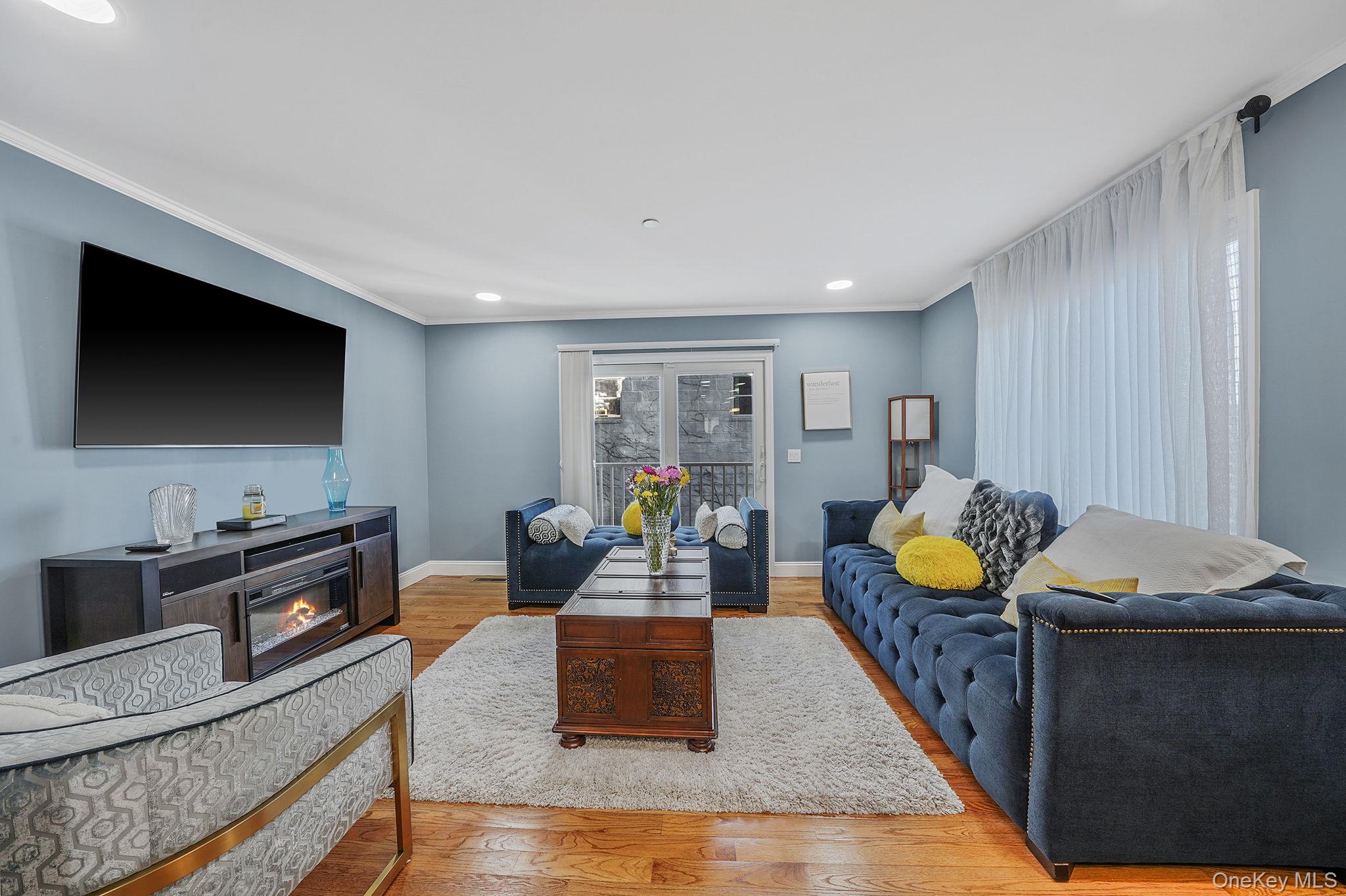 531 Ray Street, Unit 10 Freeport, NY 11520 - Photo 6 of 32 a living room with furniture and a flat screen tv