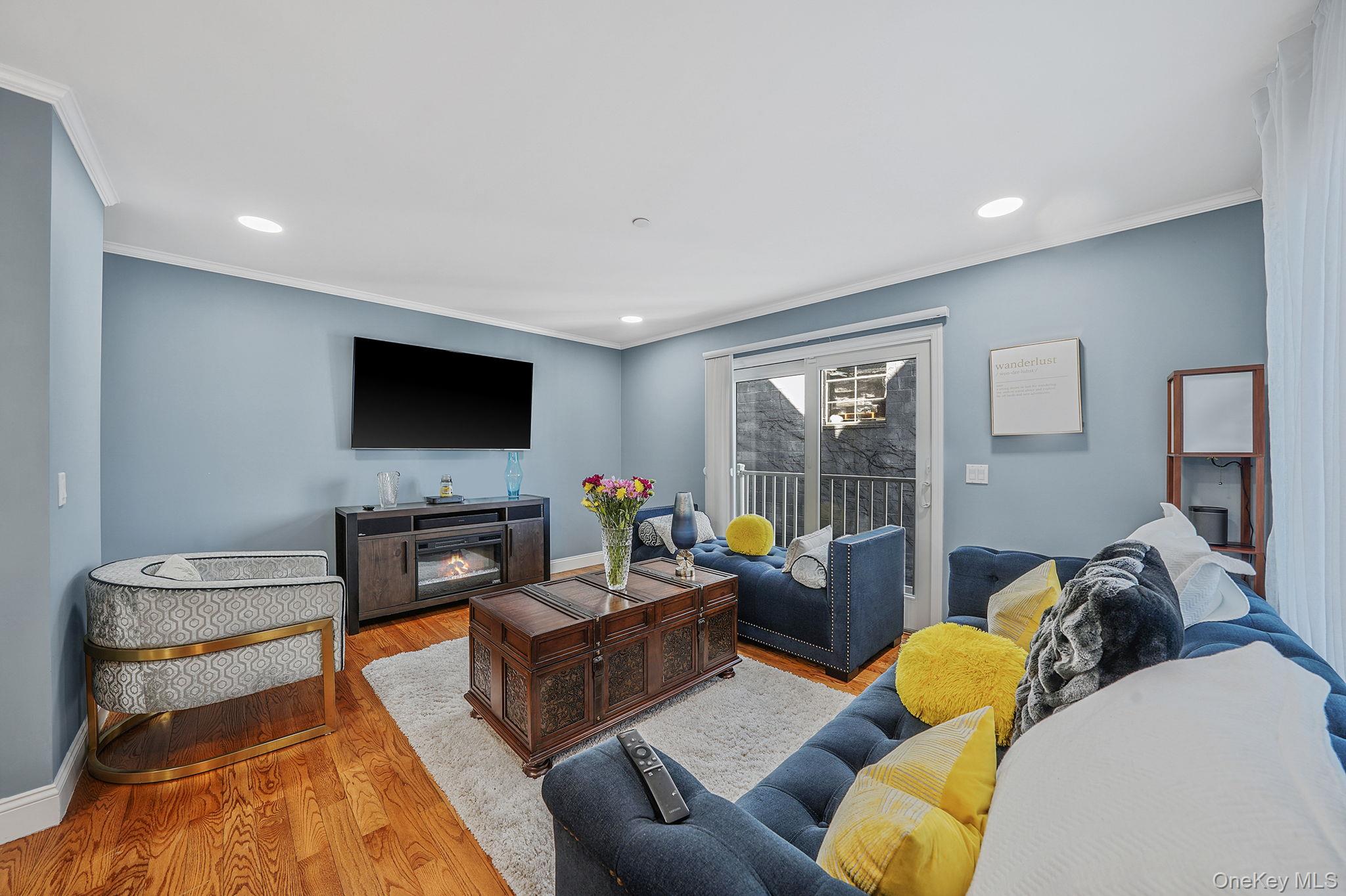531 Ray Street, Unit 10 Freeport, NY 11520 - Photo 7 of 32 a living room with furniture and a flat screen tv
