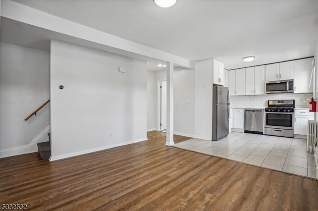 a view of kitchen with wooden floor electronic appliances and window