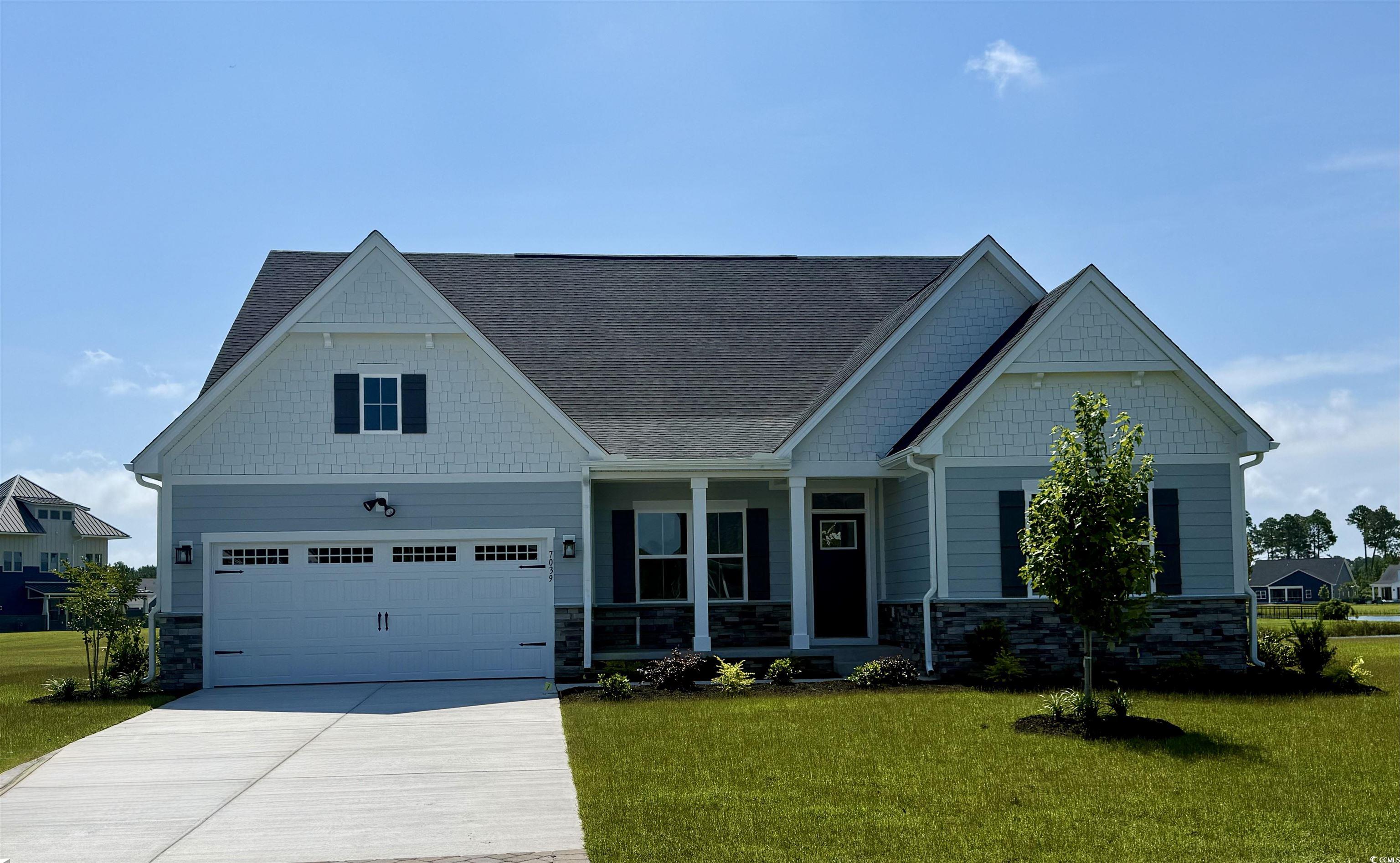 Craftsman-style house with a garage and a front ya