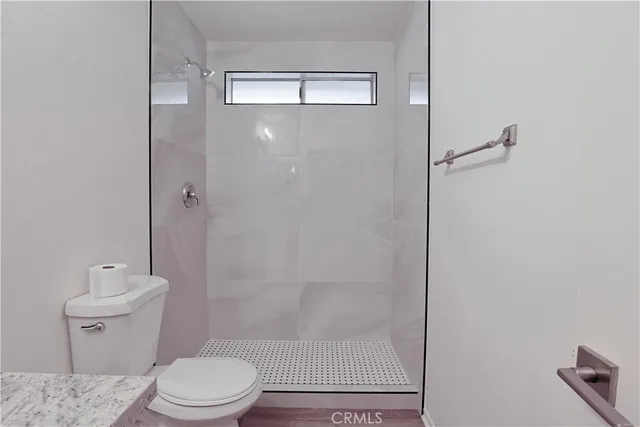 a bathroom with a toilet a sink and shower