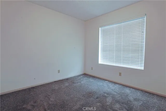 a bathroom with a granite countertop sink toilet and mirror