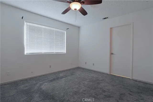 a bathroom with a granite countertop sink and a toilet
