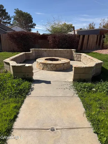a view of a backyard with sitting area