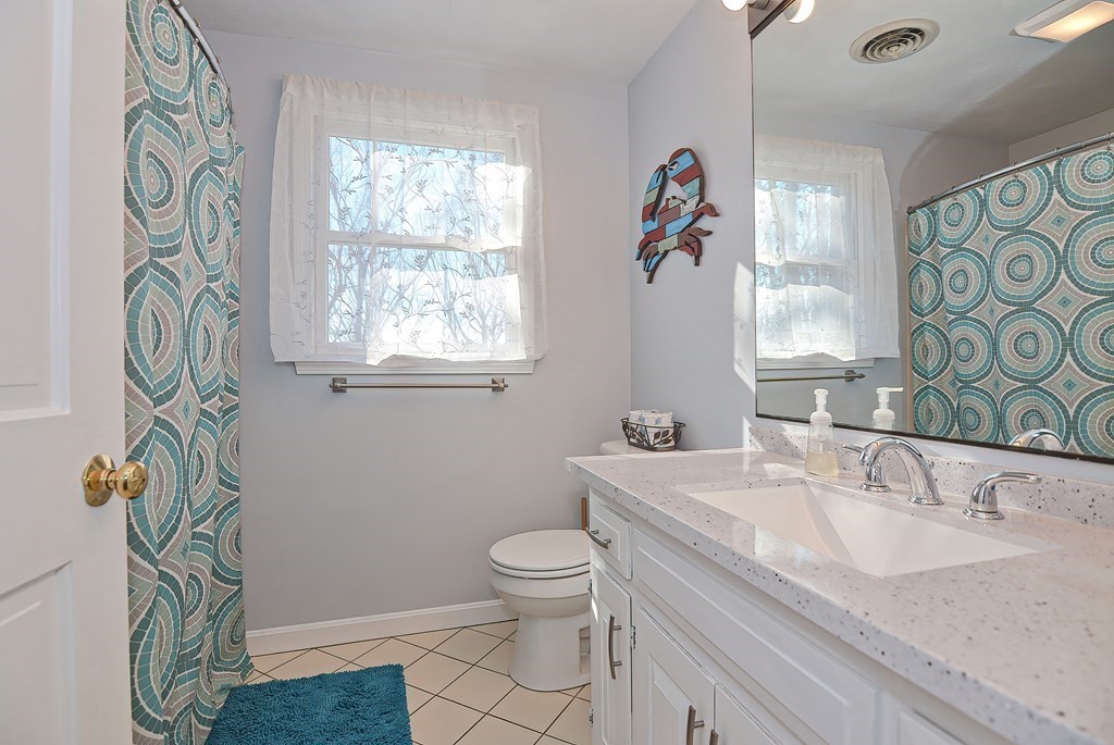 3 Jackson Circle Franklin, MA 02038 - Photo 15 of 25 a bathroom with a sink a toilet and a window