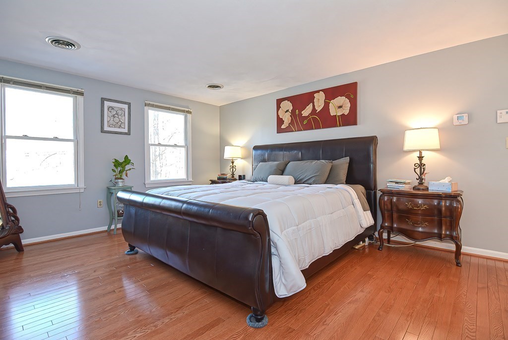 3 Jackson Circle Franklin, MA 02038 - Photo 16 of 25 a spacious bedroom with a bed and wooden floor
