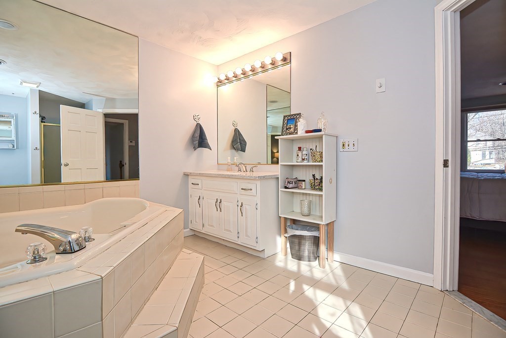 3 Jackson Circle Franklin, MA 02038 - Photo 18 of 25 a bathroom with a bathtub sink and a mirror
