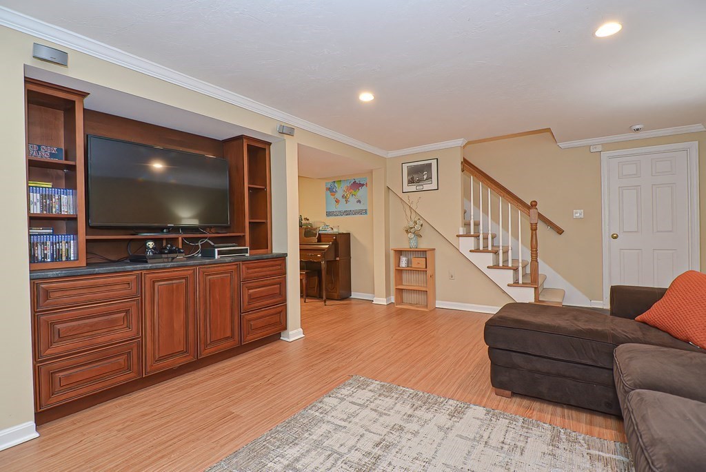 3 Jackson Circle Franklin, MA 02038 - Photo 21 of 25 a living room with furniture and a flat screen tv