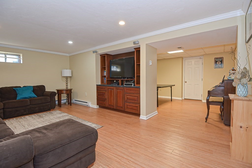3 Jackson Circle Franklin, MA 02038 - Photo 22 of 25 a living room with furniture and a flat screen tv