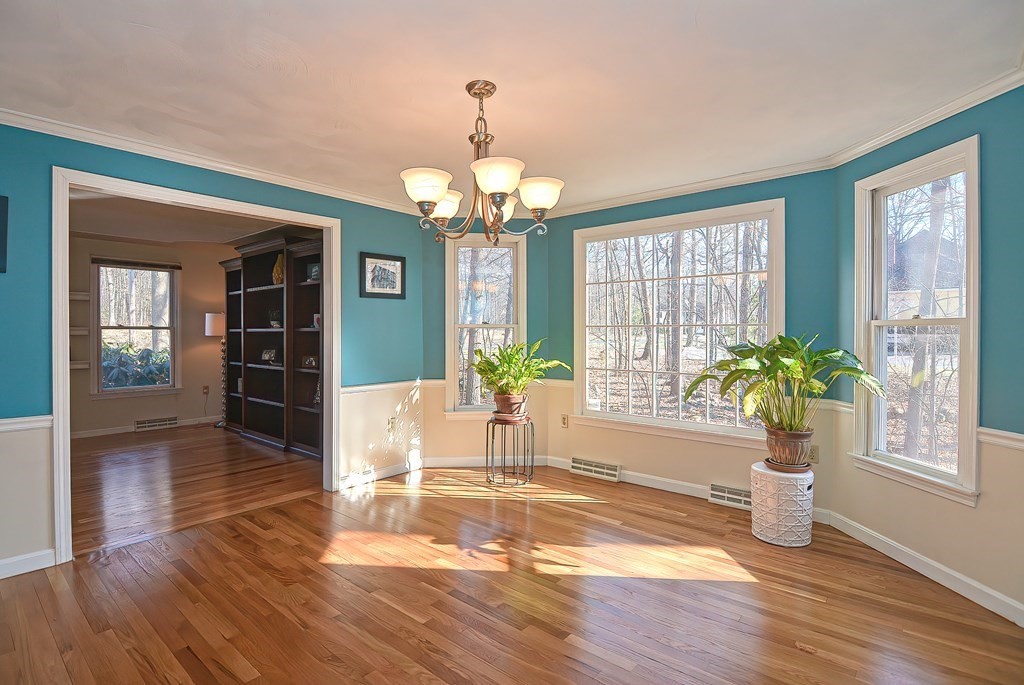 3 Jackson Circle Franklin, MA 02038 - Photo 8 of 25 a dining room with wooden floor a chandelier a glass table and windows