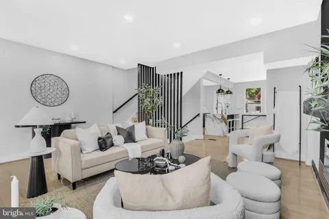 a living room with furniture and a clock