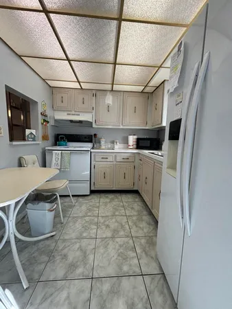 a kitchen with stainless steel appliances granite countertop a sink and cabinets