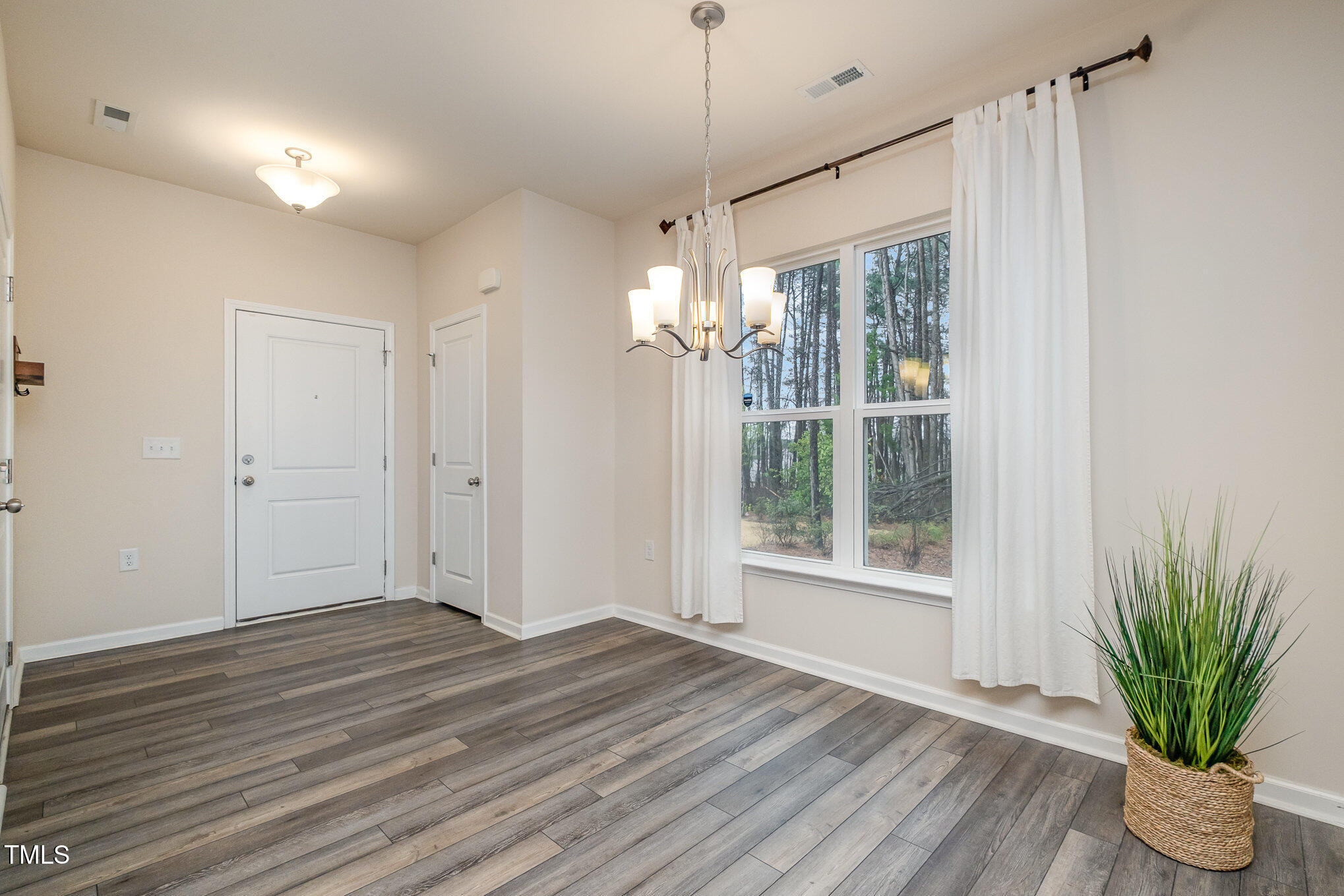 4220 Congleton Place Durham, NC 27703 - Photo 9 of 35 a view of an empty room with wooden floor and a window