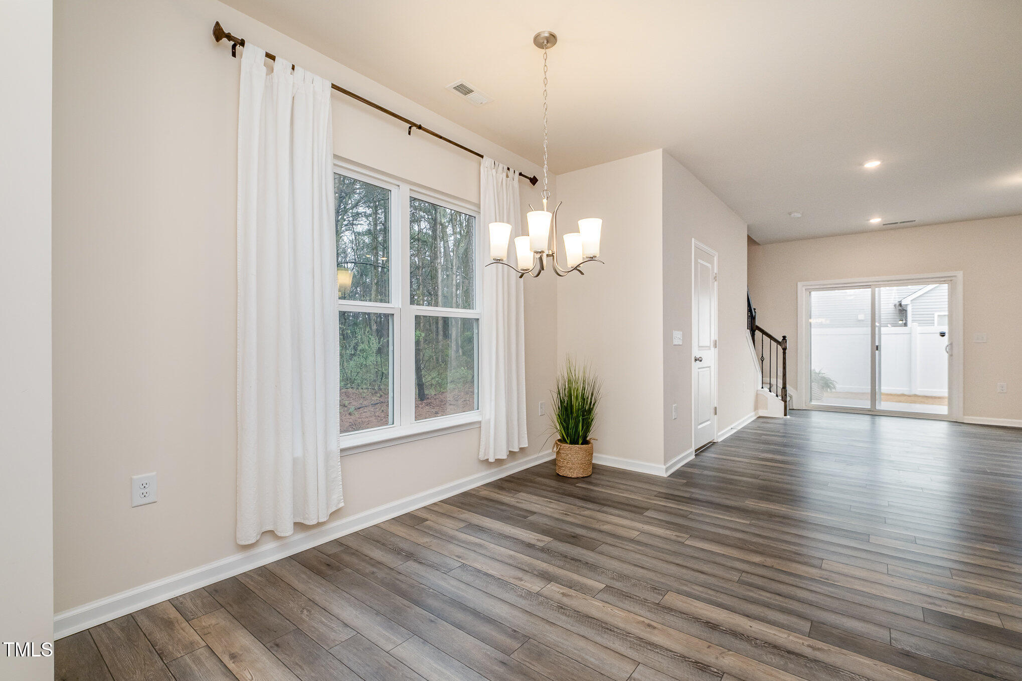 4220 Congleton Place Durham, NC 27703 - Photo 10 of 35 a view of an empty room with wooden floor and a window