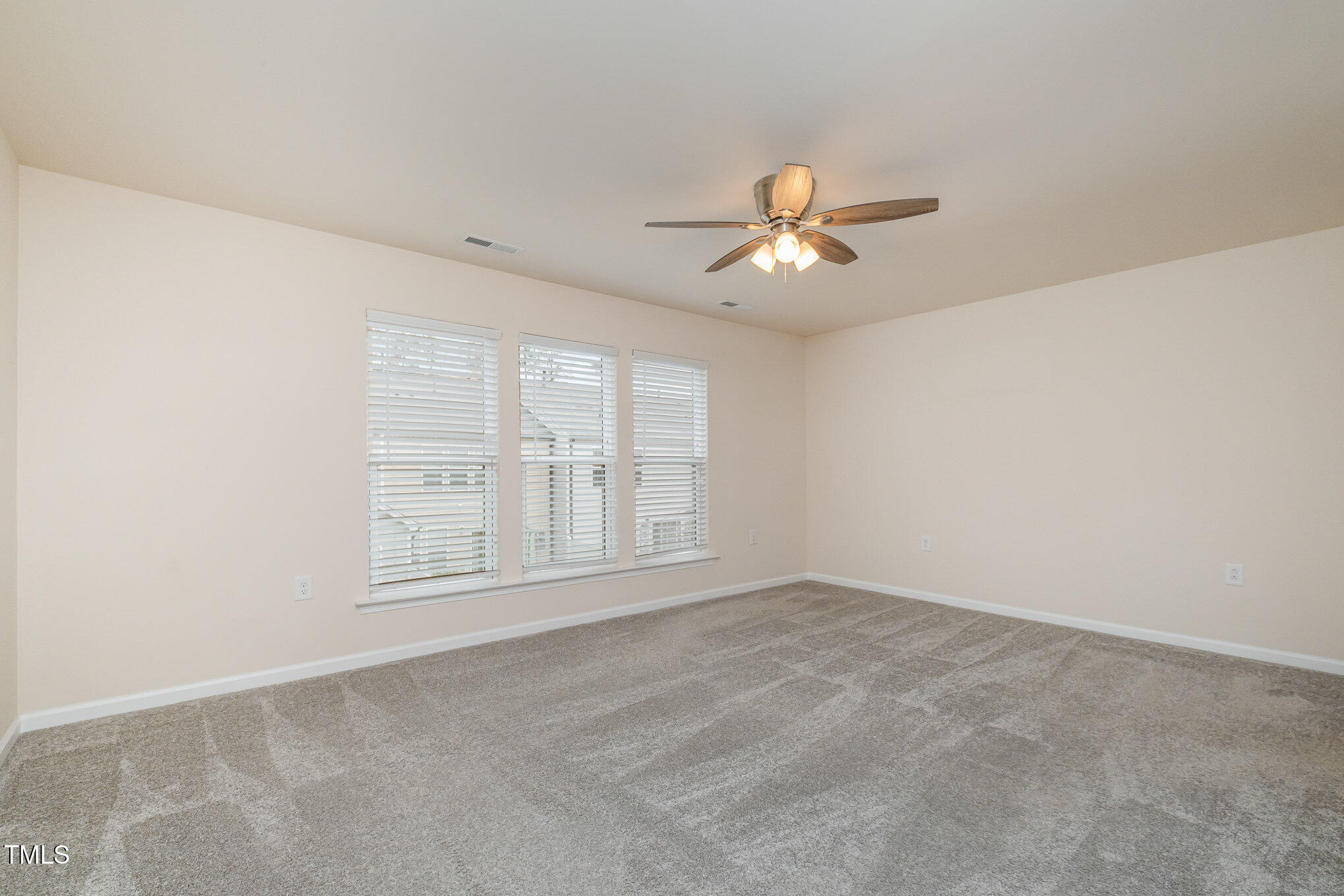 4220 Congleton Place Durham, NC 27703 - Photo 14 of 35 an empty room with chandelier fan and windows
