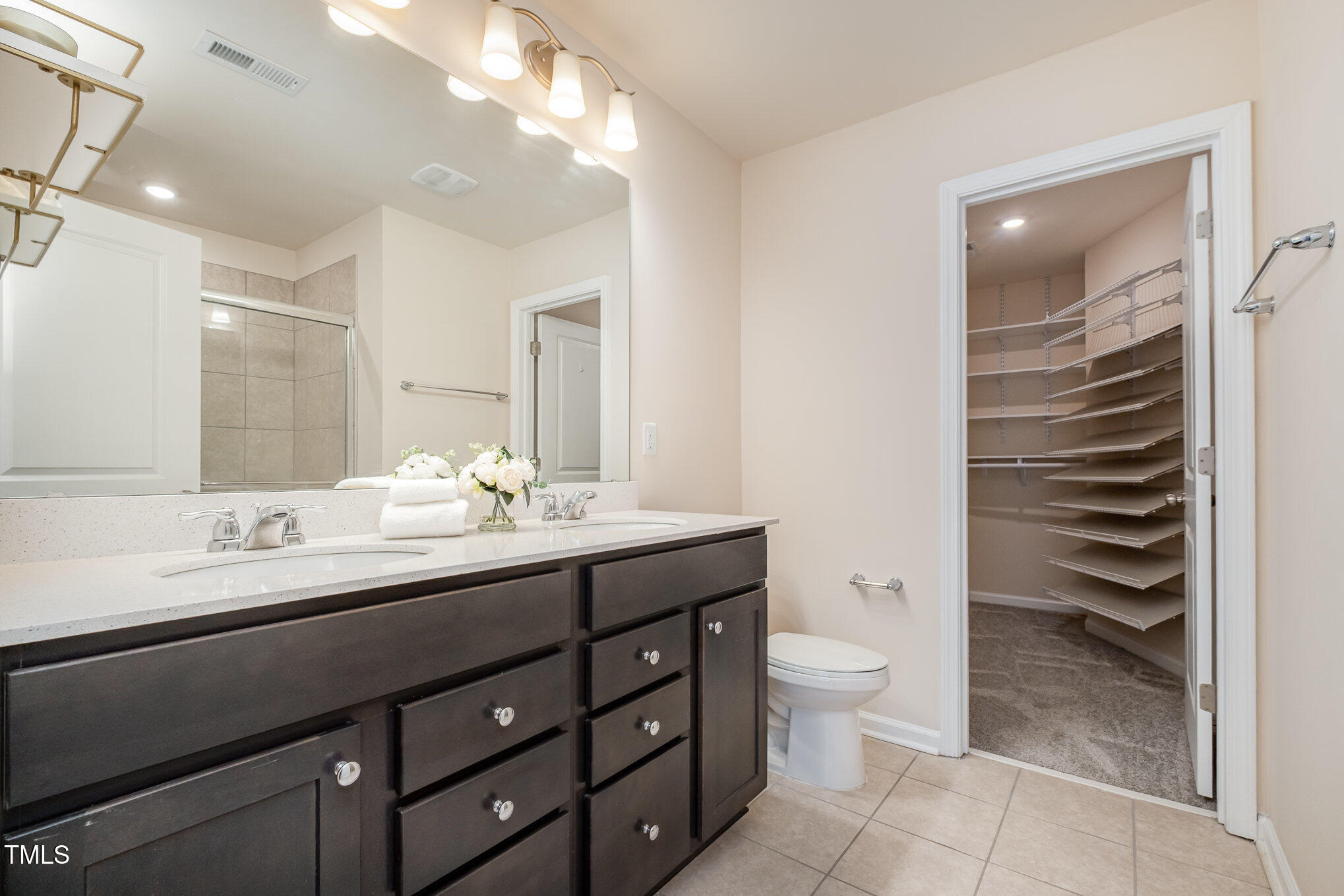 4220 Congleton Place Durham, NC 27703 - Photo 16 of 35 a bathroom with a granite countertop sink a toilet and shower