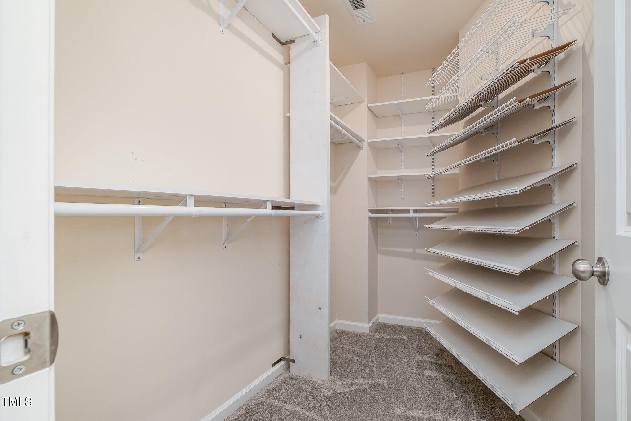 4220 Congleton Place Durham, NC 27703 - Photo 18 of 35 a view of walk in closet with empty racks