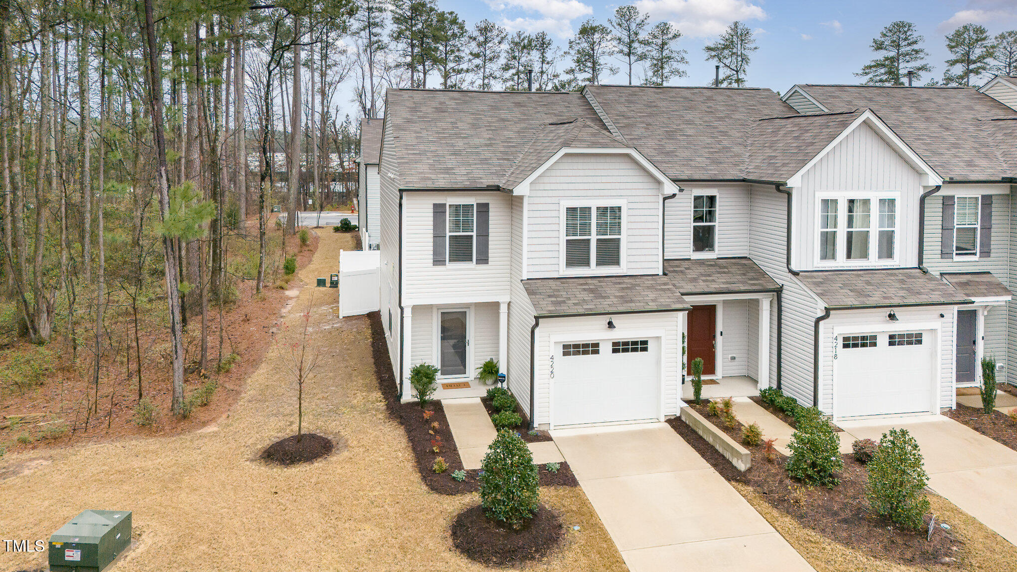 4220 Congleton Place Durham, NC 27703 - Photo 28 of 35 a view of a white house with large windows next to a yard