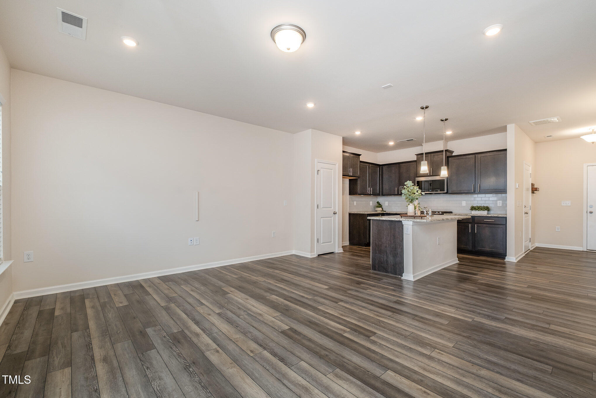 4220 Congleton Place Durham, NC 27703 - Photo 6 of 35 a open kitchen with kitchen island a sink dishwasher and a stove with wooden floor