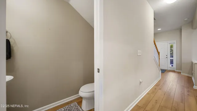 a bathroom with a toilet and a balcony