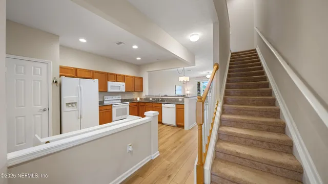 a view of kitchen with sink and wooden floor